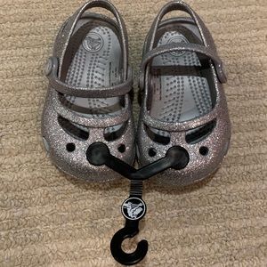 Brand new silver sparkly Crocs- size 4